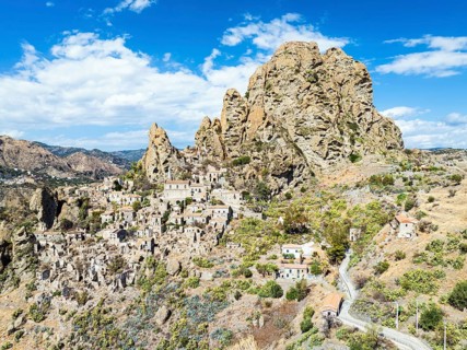 Mountains and Olive groves around Ghost Town from a drone, Pentedattilo Village, Calabria, Italy,