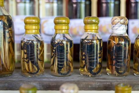 Choum, rice liquor, rice wine with pickled scorpions and snakes for sale, Laos, Asia