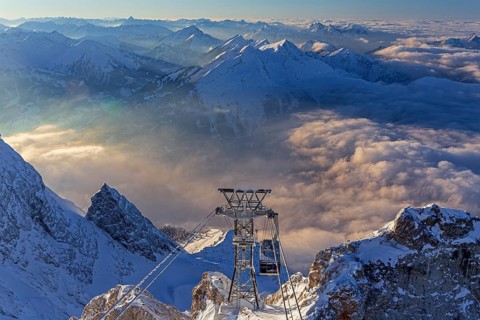 Mountain peak above high fog, cable car, evening light, winter, view from Zugspitze to Ehrwalder