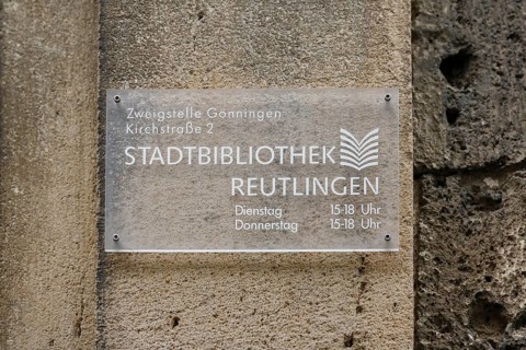 Sign on the old schoolhouse, building from 1867 made of Gönningen tuff, former elementary and