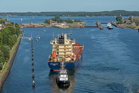 Cargo ship waiting in front of the lock, tugboat, Kiel Canal, Holtenau, Kiel, Schleswig-Holstein,