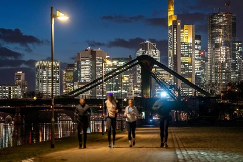 Skyline of the city centre of Frankfurt am Main, joggers on the pavement, promenade along the river