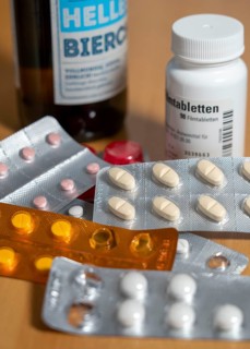 Symbolic image of alcohol and medication, you should not take medicine, pills, tablets with