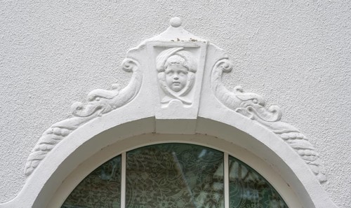 Relief of a boy's head above the fenaster of the oldest kindergarten in Lauf, 1850, Alter Schulhof