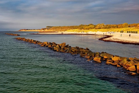 Baltic Sea beach, walkers on the Baltic Sea coast on Wustrow beach in the evening light, evening