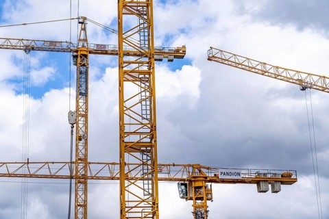 Construction cranes, on a large construction site in Düsseldorf, construction of condominium in the