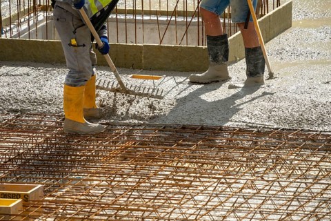 Construction site, concreting, the floor slab of a building is concreted, the concrete is pumped
