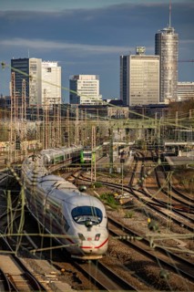 Train on the tracks west of Essen central station, skyline of the city centre, ICE train, North