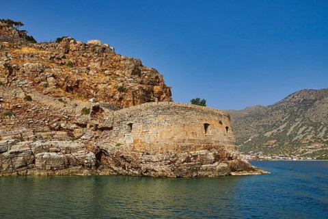 Round, stony old fortress on the seashore, embedded in a hilly landscape, Venetian sea fortress,