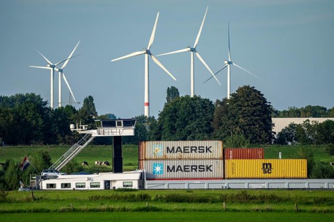 Container cargo ship on the Rhine near Emmerich, wind farm, Lower Rhine, North Rhine-Westphalia,