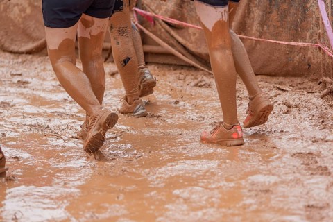 Shoes in the mud during a dynamic outdoor obstacle course
