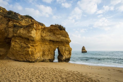 Rocky coast with beach and red rocks, Praia do Camilo, Lagos, Algarve, Portugal, Europe
