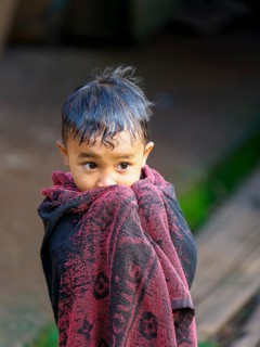 Boy with towel, Limbong village, Tana Toraja, Sulawesi, Indonesia, Asia