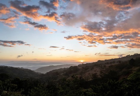 View to the sea over wooded hills, at sunset, cloud forest, Monte Verde, Puntarenas province, Costa