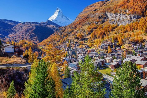 View of the village with Matterhorn 4478m and golden yellow larches in autumn, Zermatt, Mattertal,