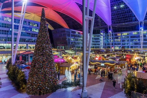Christmas market at the airport in the evening, market stalls decorated for Christmas in front of