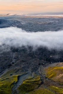 Fog, clouds moving around, glacier ice of the Kötlujökull glacier tongue at sunset, Myrdalsjökull