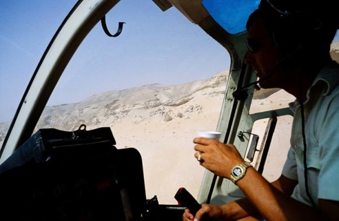 Oil industry Saudi Arabia, helicopter Bell 206 JetRanger 1979 Pilot in cockpit flying over desert