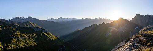 Panorama, mountain landscape at sunrise with sun star, view of mountain peaks of the Venediger