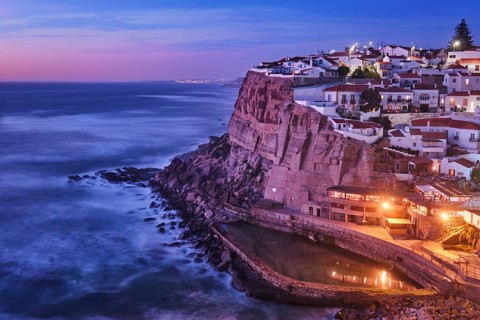 Scenic view of the seaside Azenhas do Mar fishing village on cliff on Atlantic ocean coast,