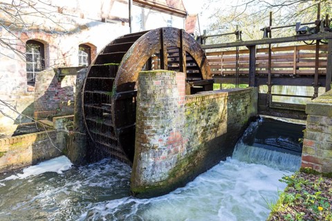 Water wheel with hydroelectric power plant of the Dölitz water mill, Leipzig, Saxony, Germany,