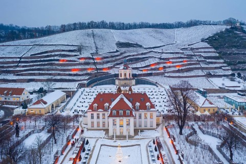 Aerial view of Wackerbarth Castle with castle park, belvedere and vineyards with snow and Christmas