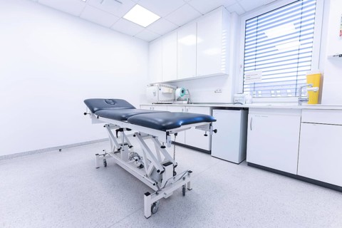 Modern clinic room with examination couch and window, bright and sterile, Urology, Germany, Europe