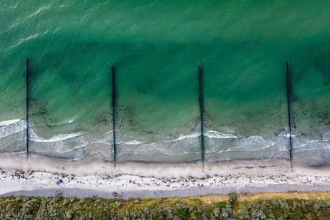 Aerial view over wooden groynes protection shoreline near Wustrow on the Fischland peninsula along
