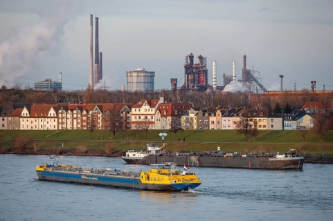 Duisburg, North Rhine-Westphalia, Germany - Cityscape in the Ruhr area with cargo ship on the Rhine