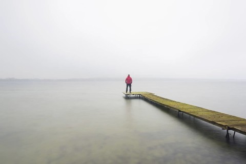 Man on wooden jetty at Großer Plöner See, Great Plön Lake, Lake Plön, Grosser Ploener See in