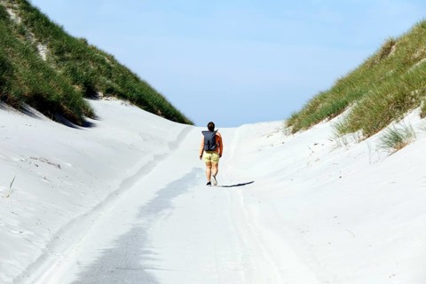 A woman walks to the beach on the island of Amrum, Norddorf, 15.06.2020