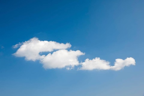 White fleecy clouds adorn the blue sky