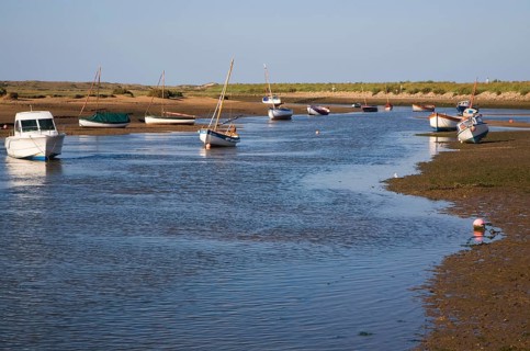 Boats in a tidal creek at Burnham Overy Staithe, north Norfolk coast, England, United Kingdom,