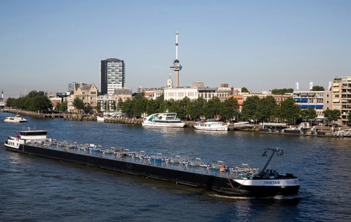 River barge chemical transporter ship 'Tristan' passing Euromast in the city, River Maas, Port of