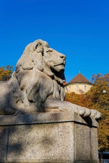 Resting lion made of granite on the terraced base of the equestrian statue of Emperor Wilhelm I on