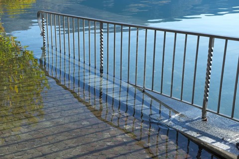 Street with Railing on Flooding lake Maggiore on the Waterfront in a Sunny Day with Sunlight in