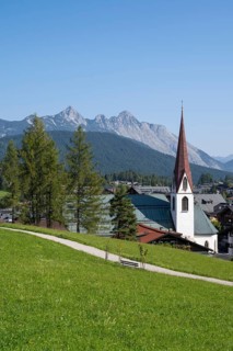 View of the village with St Oswald parish church, Karwendel mountains, view from the parish hill,