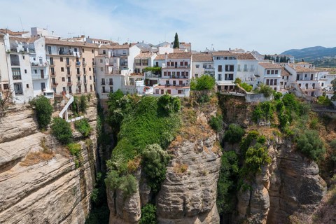 Spanish town with white houses in it situated above a spectacular gorge, view from El Puente Nuevo,
