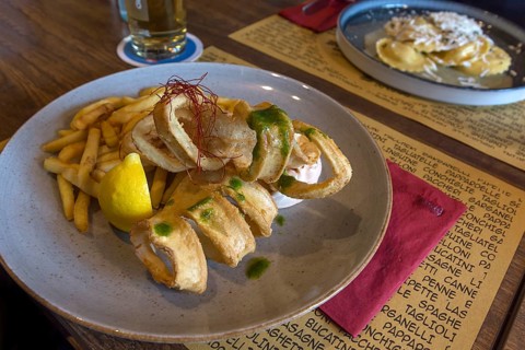 Squid baked with fries served in a pizzeria, Franconia, Bavaria, Germany, Europe