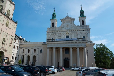 Large church with columned façade and parked cars in front, St John's Cathedral, Lublin, Poland,