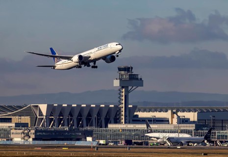 Aircraft taking off in front of the hangar and tower at Fraport Airport. Aircraft registration