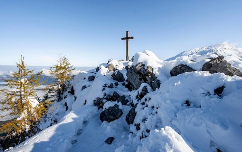 Snow-covered summit of the Jenner with summit cross in autumn, Berchtesgaden National Park,