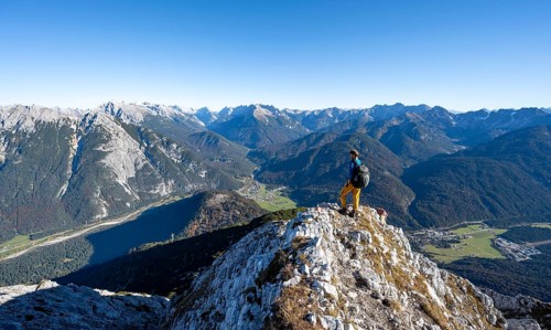 Mountaineer at the summit of the Große Arnspitze, mountain panorama with Karwendel mountains,