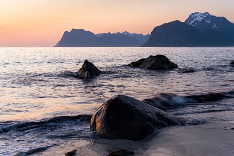 Seascape. On the beach at Myrland. Rocks and sea, with Mount Hogskolmen in the background on the