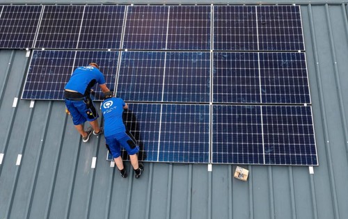 Installation of solar modules on the roof of a barn on a farm, over 240 photovoltaic modules are