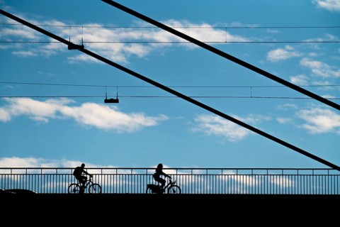 Cyclist, on the Rheinknie Bridge in Düsseldorf, North Rhine-Westphalia, Germany, Europe