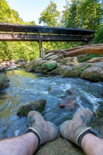 The Irrel Waterfalls, rapids in the lower reaches of the Prüm, covered wooden bridge for hikers,