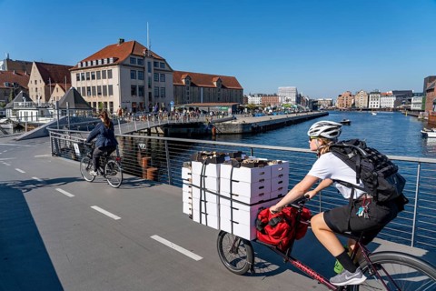 Cyclists on the Inderhavnsbroen cycle and footpath bridge, over the harbour, at Nyhavn, Copenhagen