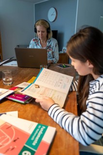 Homeschooling, during the lockdown in January 2021, children learn at home for school, their mum is