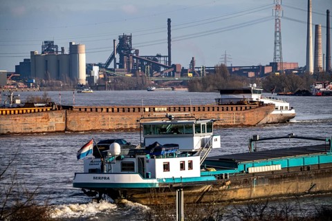 The Rhine near Duisburg, cargo ships, backdrop of the ThyssenKrupp Steel steelworks in Duisburg